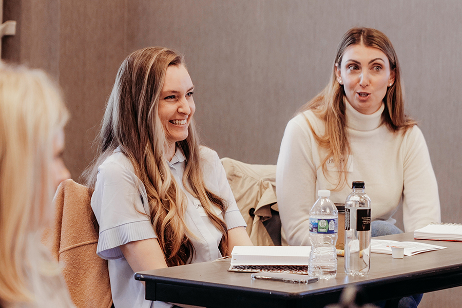 Women around a table talking animatedly